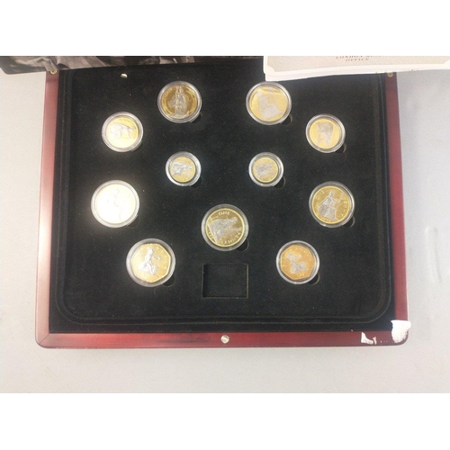 60 - Two cases of plated coins in cases to include pre-decimalisation coins and coins of Britannia.#60... 