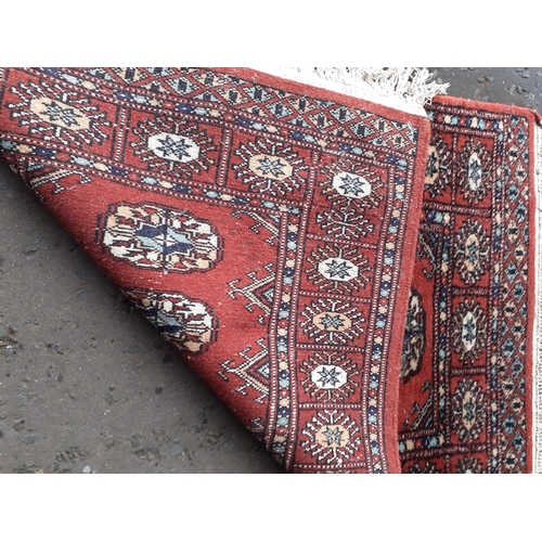 114 - A small fringed red rug with 6 centre medallions 95x66cm approx#25