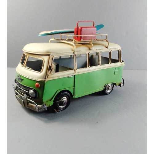 128 - A tinplate VW CAMPER VAN complete with surfboard and cooler on the roof rack. Measures 30x12cm appro... 