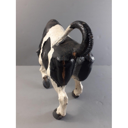 147 - A wooden bull with attitude standing 22cm approx, width 26cm approx.  Has suffered some damage.#41... 