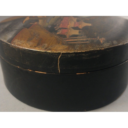 235 - A black lacquered round box with an Japanese design with Mount Fuji in the background, diameter 18cm... 