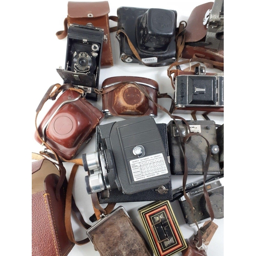 262 - A box of vintage cameras to include OLYMPUS OM20 with 50mm lens, and a TAMRON 80-210mm lens, a KUARZ... 