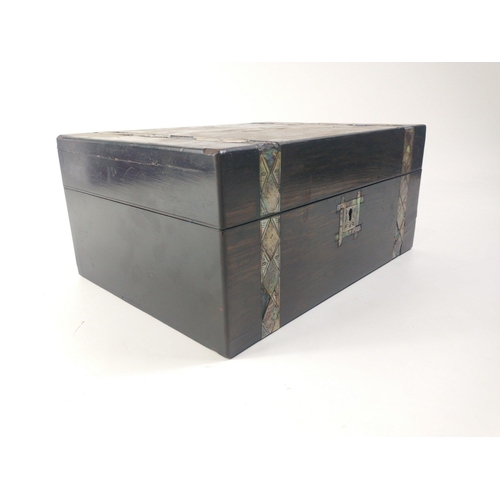 67 - A large dark wood jewellery box (30x22x14cm approx) with a mother of pearl decorative band (several ... 