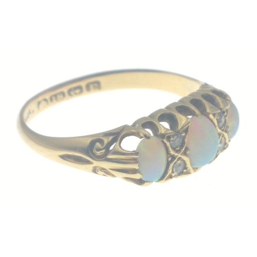 111 - An 18ct gold ring with opal and 4 diamonds (tested).  Three lovely opals with no cracks, size O, gro... 