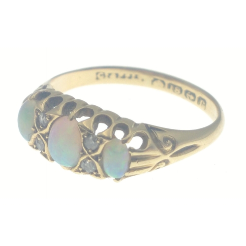 111 - An 18ct gold ring with opal and 4 diamonds (tested).  Three lovely opals with no cracks, size O, gro... 