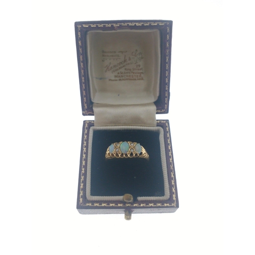 111 - An 18ct gold ring with opal and 4 diamonds (tested).  Three lovely opals with no cracks, size O, gro... 