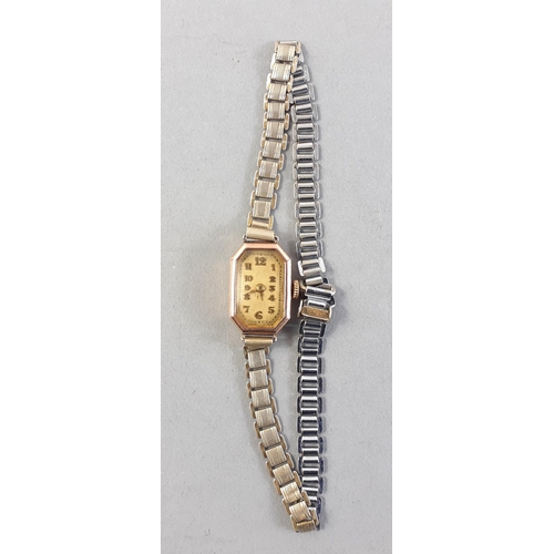 125 - A vintage octagonal faced 375 stamped yellow gold watch case with a white metal bracelet. Gross weig... 