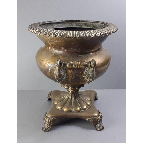 196 - An ATTRACTIVE antique brass urn effect plant holder with twin handles on a four-legged base, stands ... 