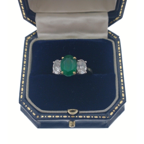 22 - A magnificent three stone Emerald and Diamond ring comprising a 2.07ct Emerald and 1.43ct of oval cu... 