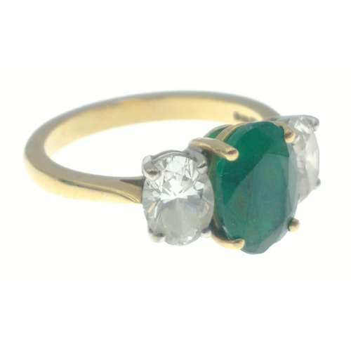 22 - A magnificent three stone Emerald and Diamond ring comprising a 2.07ct Emerald and 1.43ct of oval cu... 