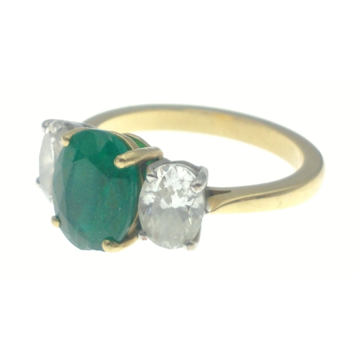 22 - A magnificent three stone Emerald and Diamond ring comprising a 2.07ct Emerald and 1.43ct of oval cu... 