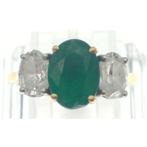 22 - A magnificent three stone Emerald and Diamond ring comprising a 2.07ct Emerald and 1.43ct of oval cu... 