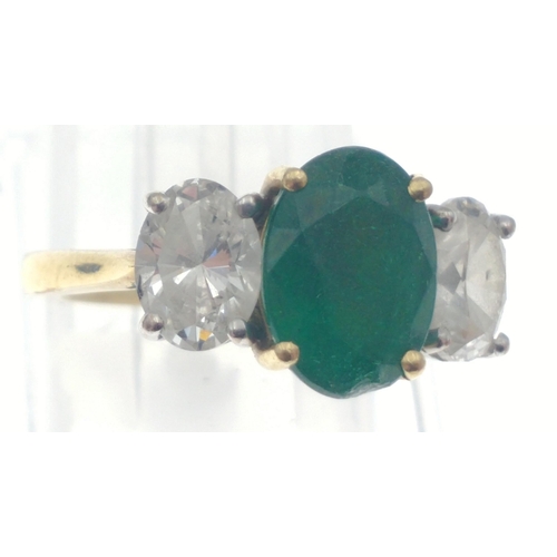 22 - A magnificent three stone Emerald and Diamond ring comprising a 2.07ct Emerald and 1.43ct of oval cu... 