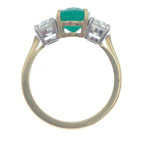 22 - A magnificent three stone Emerald and Diamond ring comprising a 2.07ct Emerald and 1.43ct of oval cu... 