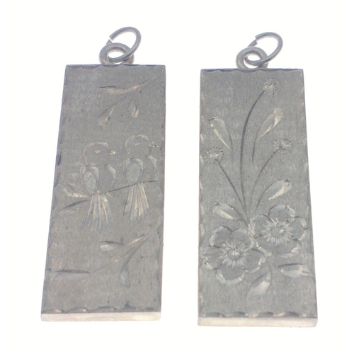 244 - Two silver hallmarked floral & fauna engraving on each silver ingot pendants - weight 30.55g app... 