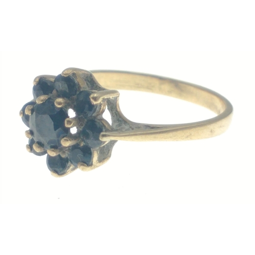 27 - A lovely 9ct gold ring with a cluster of 8 deep blue sapphires around a central sapphire. Size M.  G... 