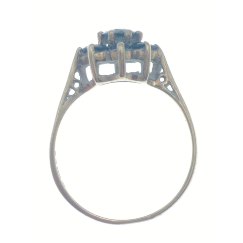 27 - A lovely 9ct gold ring with a cluster of 8 deep blue sapphires around a central sapphire. Size M.  G... 