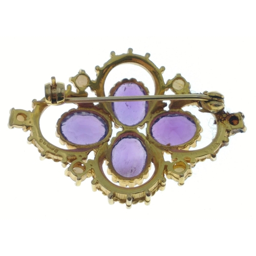 31 - A hallmarked gold brooch stamped 375, set with 4 amethysts and 6 seed pearls.  Brooch measures 40mm ... 