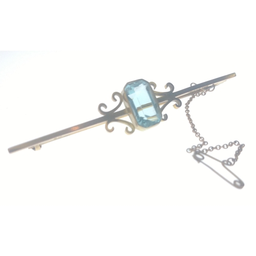 47 - A beautiful bar brooch set with an aquamarine (15mm approx) and with safety chain.  Bar stamped 9ct ... 