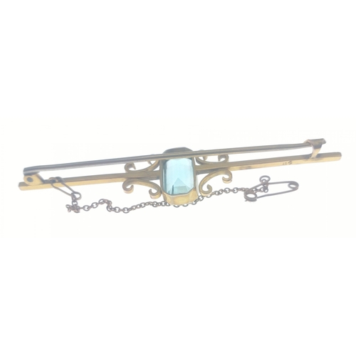 47 - A beautiful bar brooch set with an aquamarine (15mm approx) and with safety chain.  Bar stamped 9ct ... 