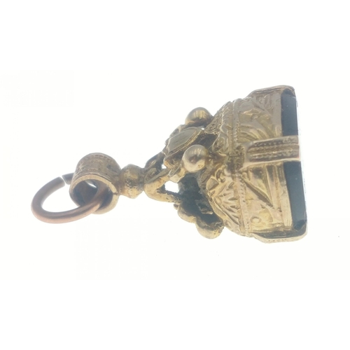 51 - A small unmarked yellow metal watch fob which does not react to a magnet 15mm long approx, gross wei... 