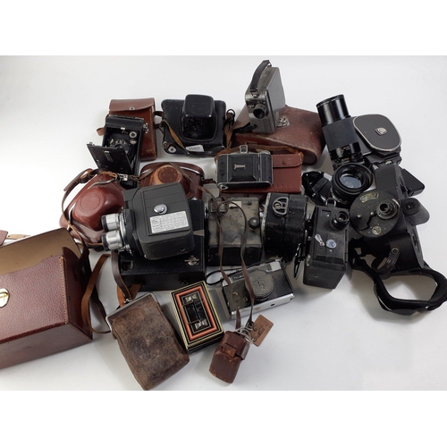 653C - A box of vintage cameras to include OLYMPUS OM20 with 50mm lens, and a TAMRON 80-210mm lens, a KUARZ... 