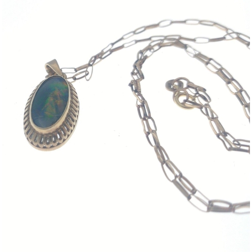 74 - A yellow metal pendant with a stunning centre oval opal (14mm oval) in an unmarked mount with 375 st... 