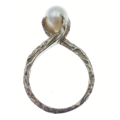 80 - An indistinctly marked yellow metal ring with a large centre natural pearl, size M, gross weight 3.3... 