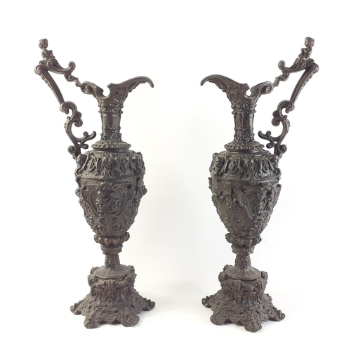 355 - A pair of 19th century GOTHIC bronzed HARVEST EWERS with flora and cherub decoration - dimensions 44... 