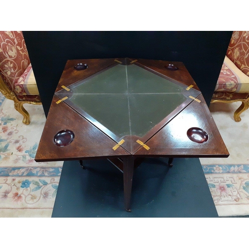 474 - An inlaid marquetry card table with four fold out quarter leaves with recessed token holders. On ori... 