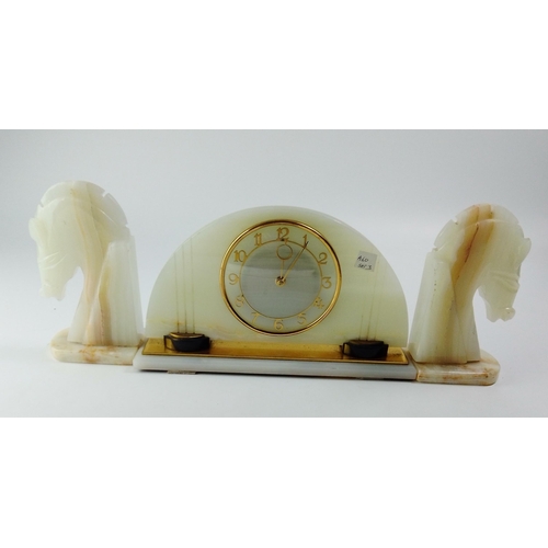 498 - An onyx mechanical mantel clock in good working order W31cm x H18cm approx.  Plus a pair of onyx sea... 