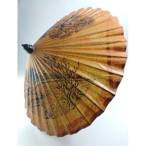 512 - An ORIENTAL bamboo and treated paper parasol with traditional rural scenes - diameter when opened 85... 