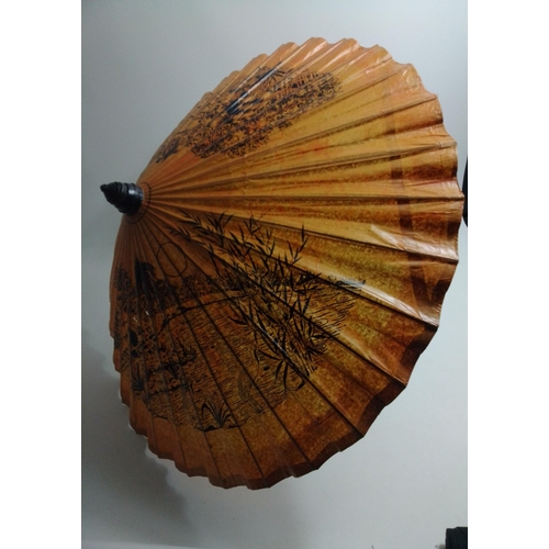 512 - An ORIENTAL bamboo and treated paper parasol with traditional rural scenes - diameter when opened 85... 