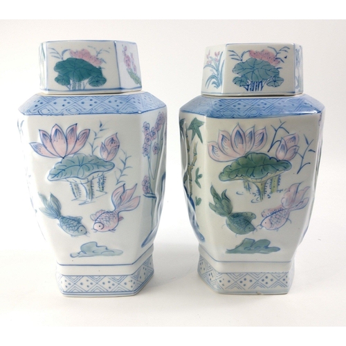 517A - Two Oriental lidded vases with 3D effect lotus and bamboo pattern.  Each stands 31cm tall inc. lids.... 