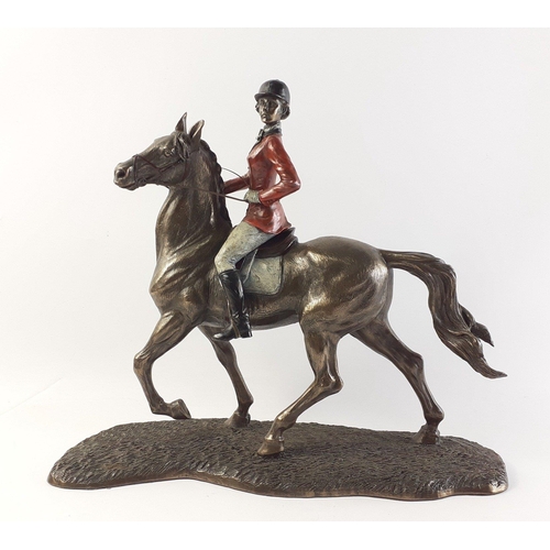 552 - A bronze effect VERONESE red coated hunting lady on a stallion.  In overall lovely condition, measur... 