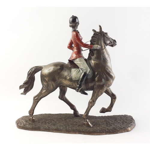 552 - A bronze effect VERONESE red coated hunting lady on a stallion.  In overall lovely condition, measur... 