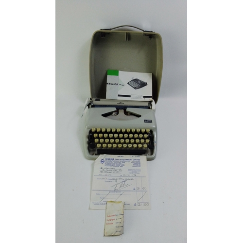 679A - A cased ADLER TIPPA S portable typewriter with paperwork work - even the original receipt from 1972 ... 