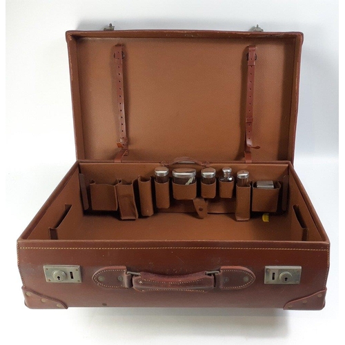 23 - A top quality leather suitcase with re-enforced corners.  Comes with lift out sections for vanity it... 