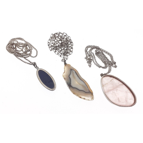 66 - A small silver lot to include 3 attractive pendants, one a polished hard stone on a silver chain, on... 