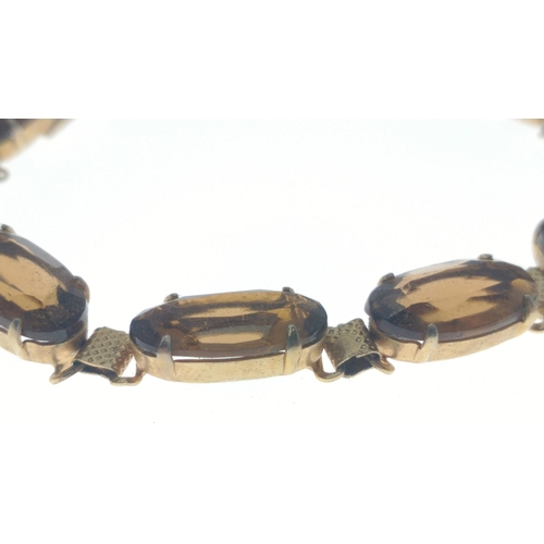 76 - A vintage gilt metal bracelet with eight amber coloured stones, 18cm long approx#77