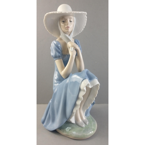 253 - A beautiful NAO figurine of a pretty sitting lady. Stands 27cm tall approx with no damage#253