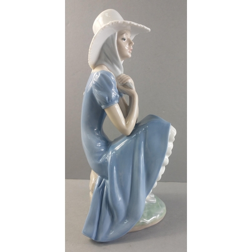 253 - A beautiful NAO figurine of a pretty sitting lady. Stands 27cm tall approx with no damage#253