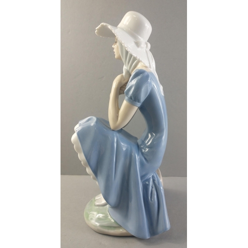 253 - A beautiful NAO figurine of a pretty sitting lady. Stands 27cm tall approx with no damage#253