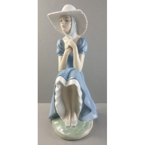 253 - A beautiful NAO figurine of a pretty sitting lady. Stands 27cm tall approx with no damage#253