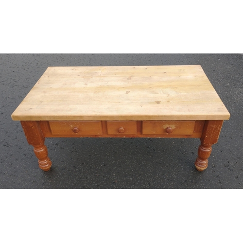 154 - A low level wooden coffee table with 3 storage drawers, measuring 120 x 70 x 50cm approx.  Needs re-... 