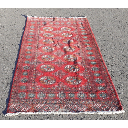 165 - A vintage PERSIAN carpet with centre design of 14 medallions with vibrant red background, 185 x 120c... 