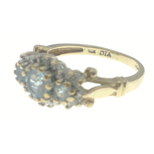 23 - A ladies dress gold ring hallmarked 9ct and stamped 10K set with sky blue topaz and diamond chips (t... 