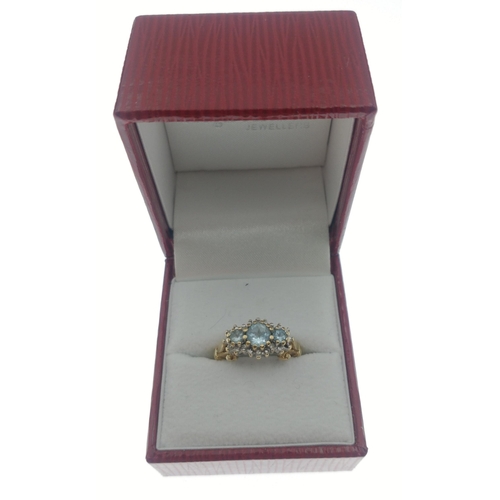 23 - A ladies dress gold ring hallmarked 9ct and stamped 10K set with sky blue topaz and diamond chips (t... 