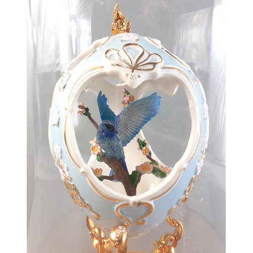 247 - A very pretty ornamental cut out ceramic egg from FRANKLIN MINT with blue bird inside presented in a... 