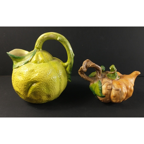 298 - Two novelty fruit based pieces to include pumpkin shaped teapot (approx 12cm tall) and a citrus jug ... 